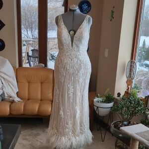 wedding dress, heavily beaded with ostrich feathers on the hem.
